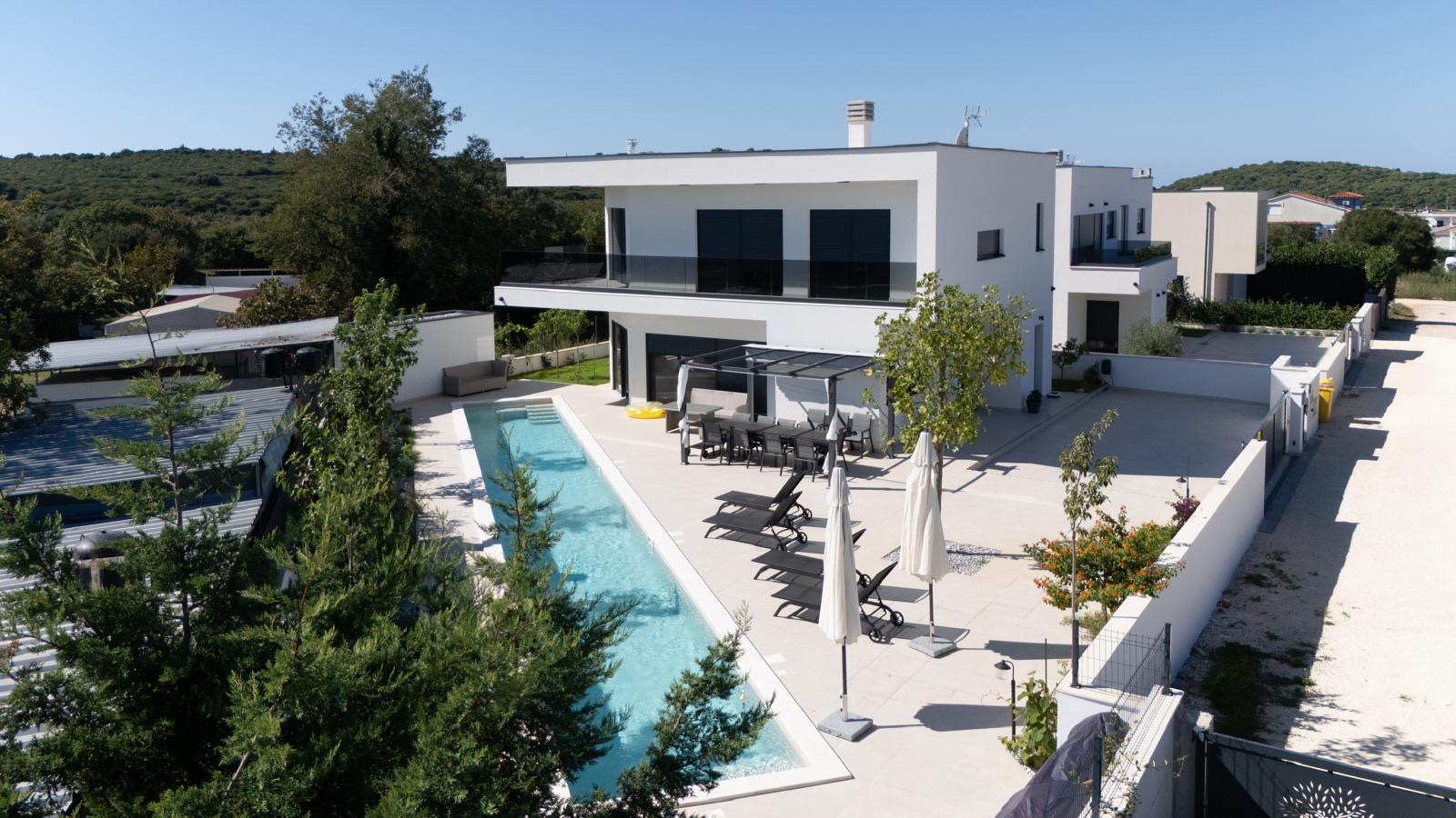 Contemporary home with a pool surrounded by Istrian landscape
